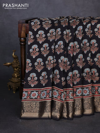 Dola silk saree black with allover ajrakh prints and zari woven border