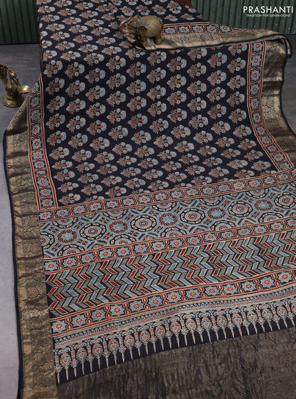 Dola silk saree black with allover ajrakh prints and zari woven border