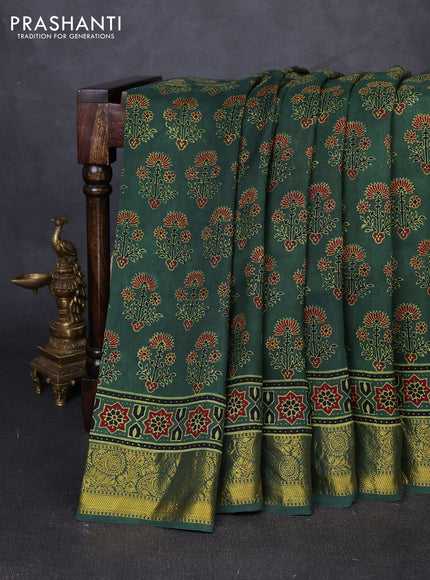 Dola silk saree green shade with allover ajrakh prints and zari woven border