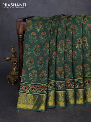 Dola silk saree green shade with allover ajrakh prints and zari woven border
