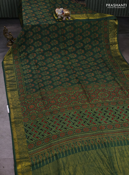 Dola silk saree green shade with allover ajrakh prints and zari woven border