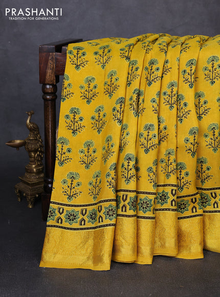 Dola silk saree yellow with allover ajrakh prints and zari woven border