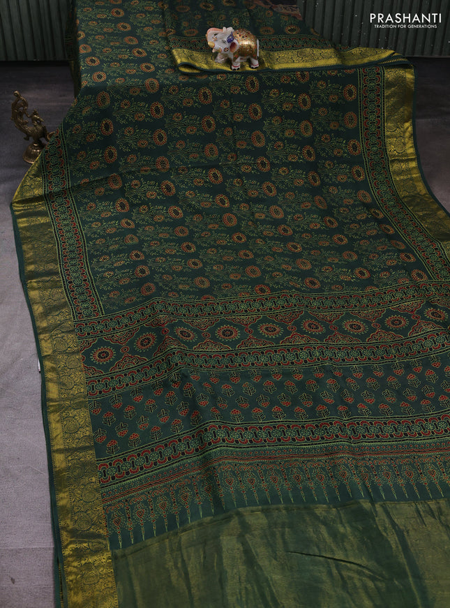 Dola silk saree green shade with allover ajrakh prints and zari woven border