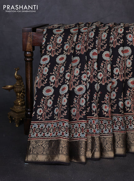 Dola silk saree black with allover ajrakh prints and zari woven border