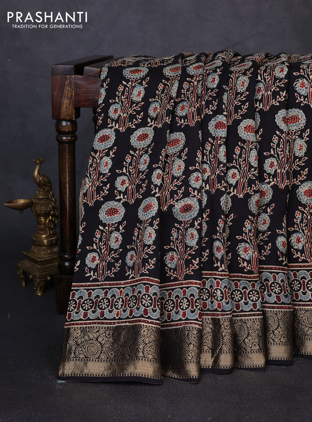 Dola silk saree black with allover ajrakh prints and zari woven border