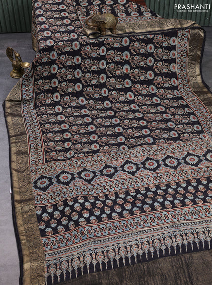 Dola silk saree black with allover ajrakh prints and zari woven border