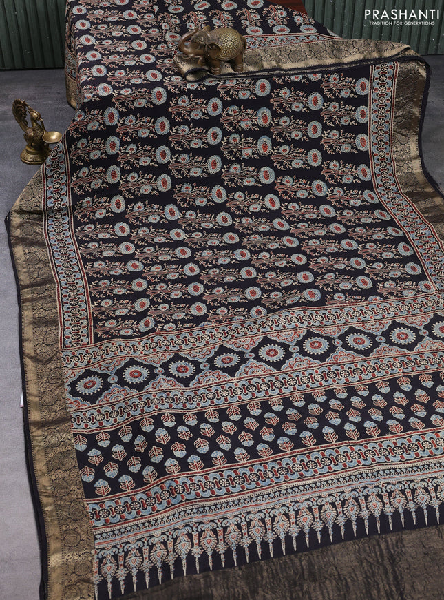 Dola silk saree black with allover ajrakh prints and zari woven border