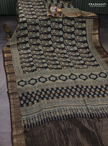 Dola silk saree black with allover ajrakh prints and zari woven border