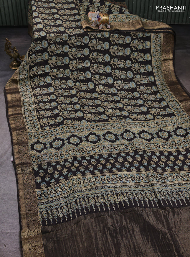 Dola silk saree black with allover ajrakh prints and zari woven border