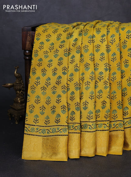 Dola silk saree yellow with allover floral butta prints and zari woven border