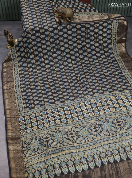 Dola silk saree black with allover floral butta prints and zari woven border