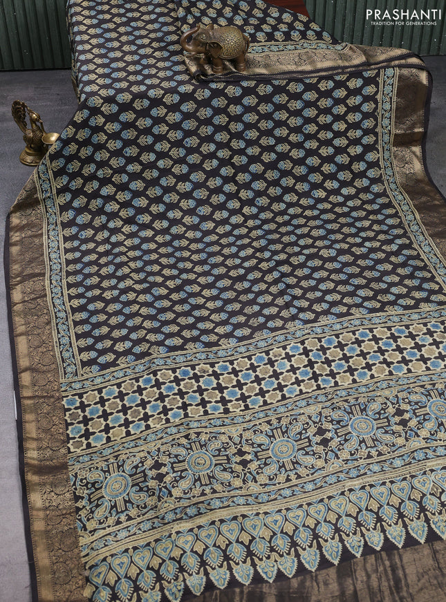 Dola silk saree black with allover floral butta prints and zari woven border
