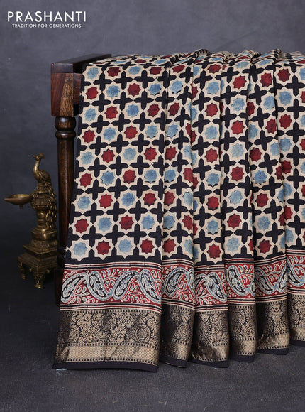 Dola silk saree black with allover floral butta prints and zari woven border