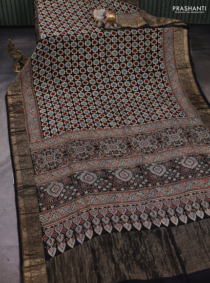 Dola silk saree black with allover floral butta prints and zari woven border