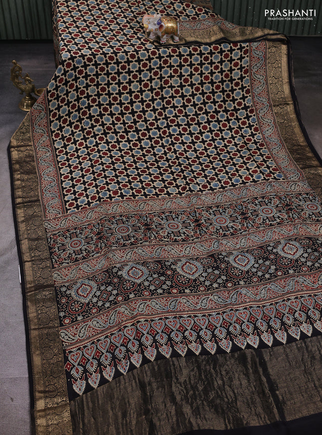 Dola silk saree black with allover floral butta prints and zari woven border