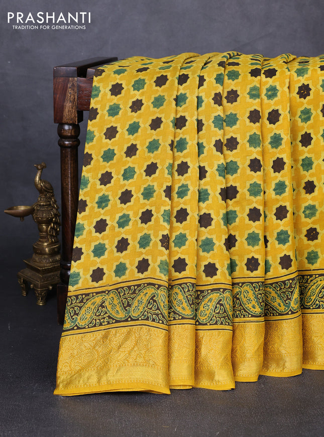 Dola silk saree yellow with allover floral butta prints and zari woven border