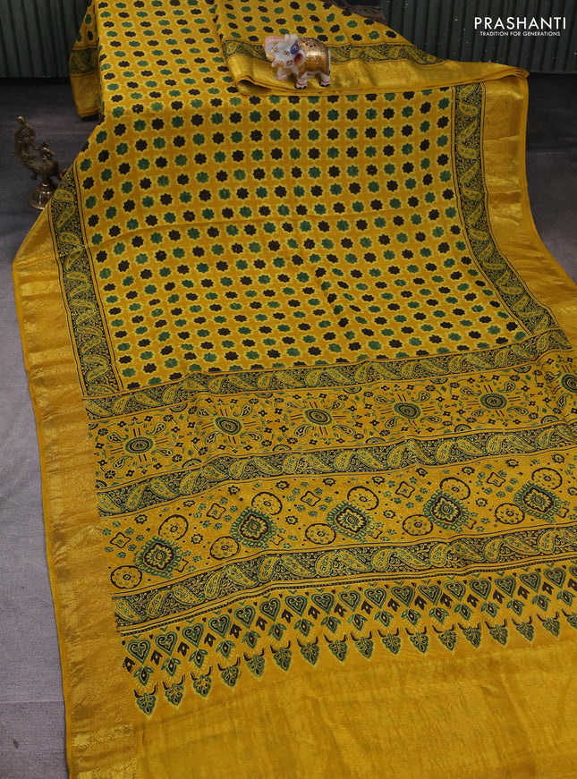 Dola silk saree yellow with allover floral butta prints and zari woven border