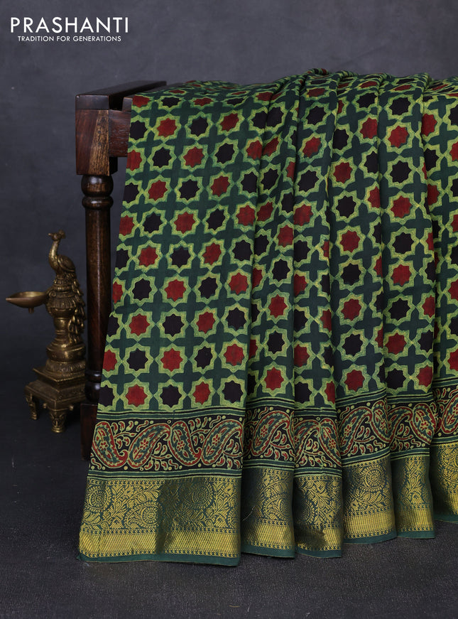 Dola silk saree green shade with allover floral butta prints and zari woven border