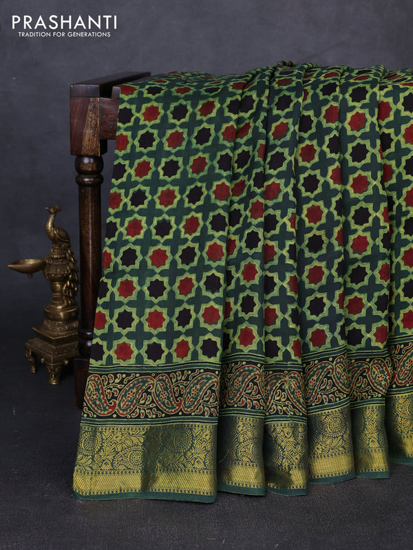 Dola silk saree green shade with allover floral butta prints and zari woven border