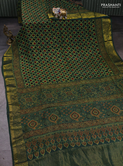 Dola silk saree green shade with allover floral butta prints and zari woven border