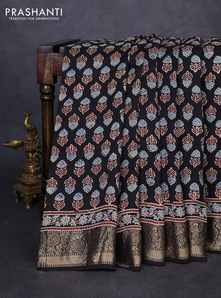 Dola silk saree black with allover floral butta prints and zari woven border