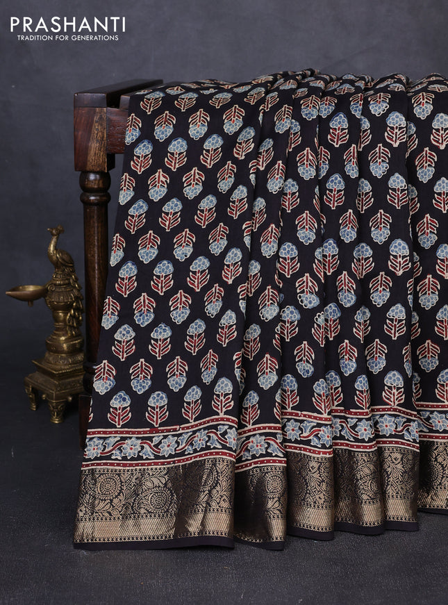 Dola silk saree black with allover floral butta prints and zari woven border