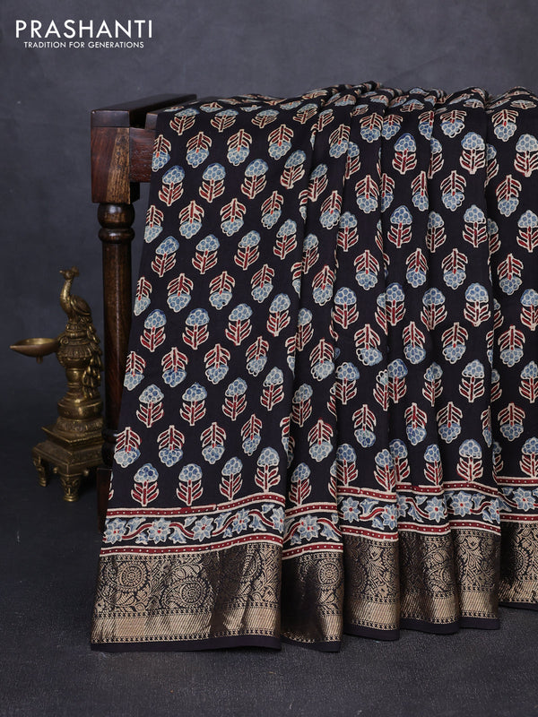 Dola silk saree black with allover floral butta prints and zari woven border
