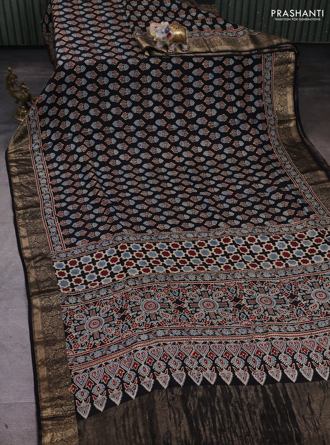 Dola silk saree black with allover floral butta prints and zari woven border