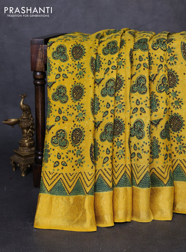 Dola silk saree yellow with allover ajrakh prints and zari woven border
