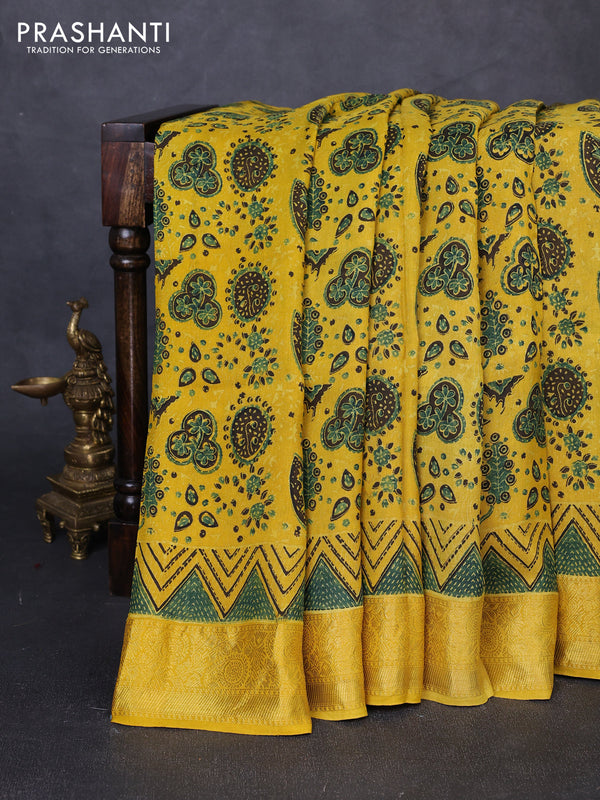 Dola silk saree yellow with allover ajrakh prints and zari woven border