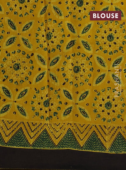 Dola silk saree yellow with allover ajrakh prints and zari woven border