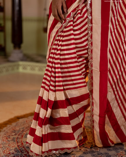 Crepe silk saree cream and pink with allover stripe pattern and mirror embroidery pallu