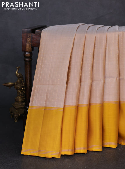 Pure soft silk saree beige and yellow with allover zari woven buttas and rettapet zari woven border