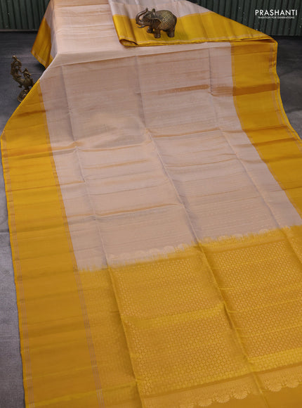 Pure soft silk saree beige and yellow with allover zari woven buttas and rettapet zari woven border