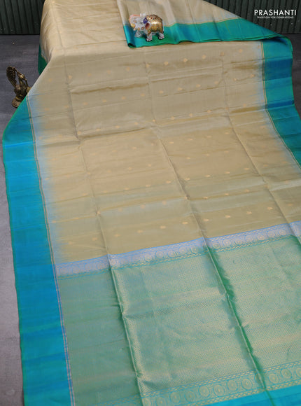 Pure soft silk saree beige and teal green with allover zari woven buttas and zari woven simple border