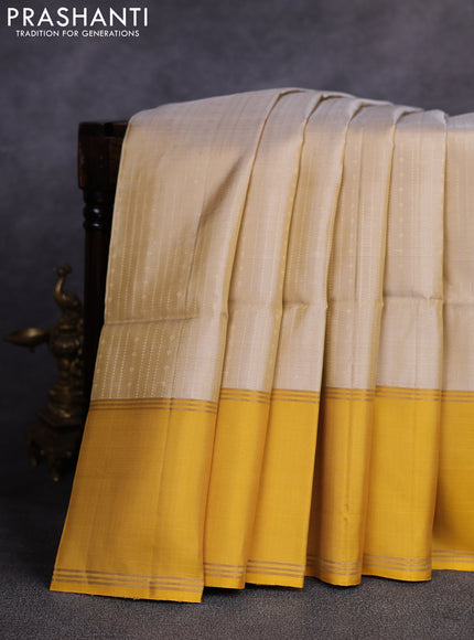 Pure soft silk saree beige and yellow with allover zari weaves pattern and rettapet zari woven border