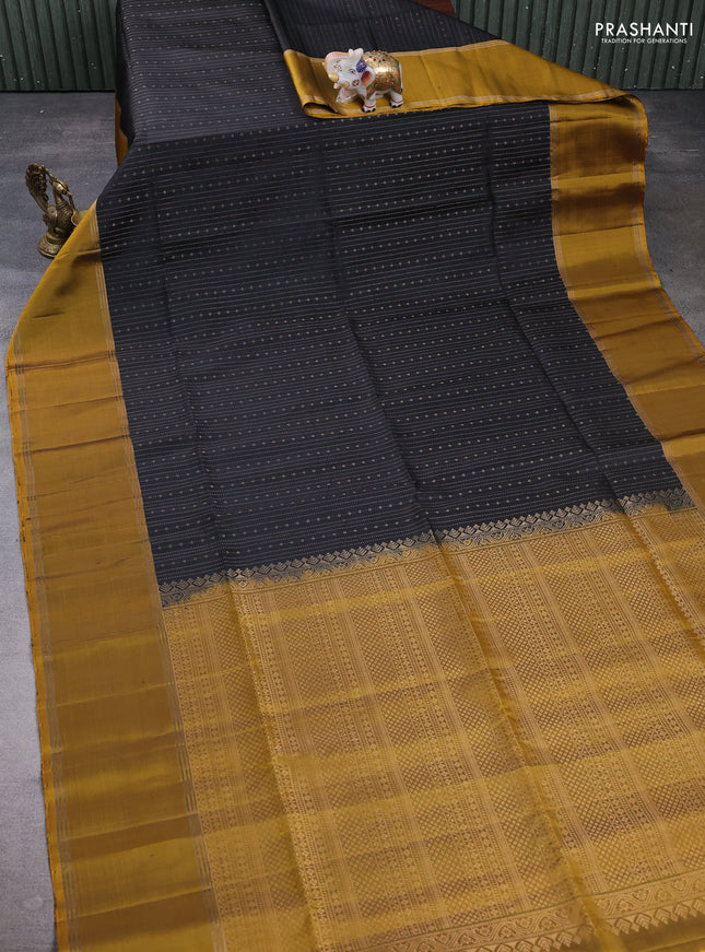 Pure soft silk saree black and mustard green with allover zari weaves pattern and rettapet zari woven border