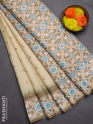 Art kota saree pale yellow and mehendi green with allover zari woven buttas and temple design ikat printed border