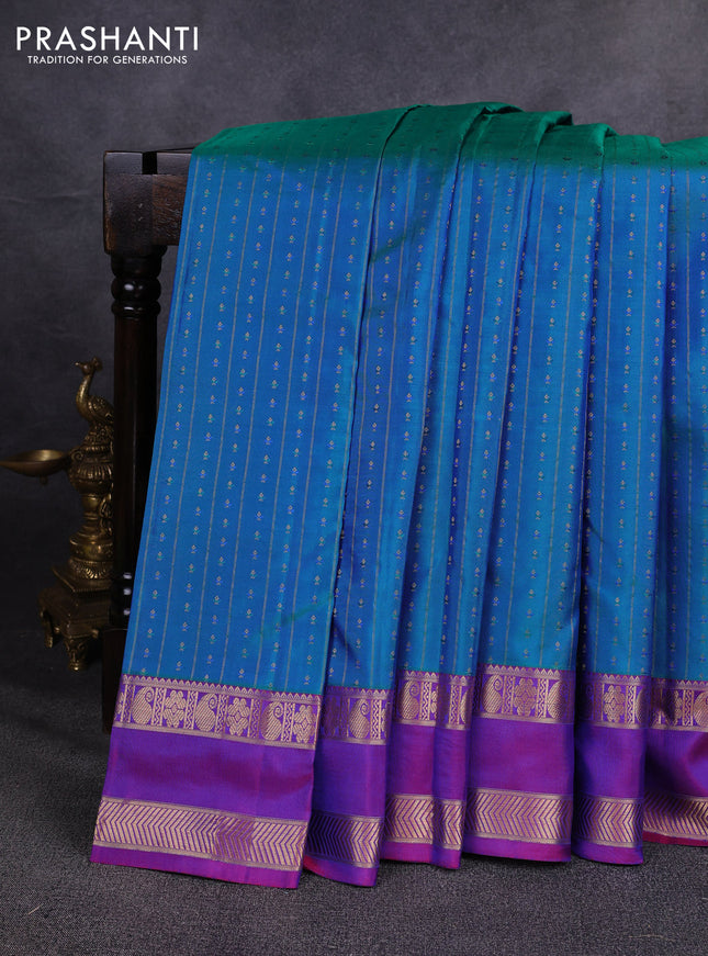 Pure kanchipuram silk saree dual shade of bluish green and purple with allover zari weaves & buttas and rettapet zari woven border