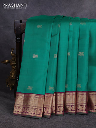 Pure kanchipuram silk saree green and magenta pink with allover zari woven buttas and zari woven korvai border