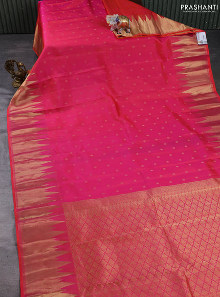 Pure kanchipuram silk saree dual shade of pinkish orange with allover zari woven buttas and temple design zari woven border