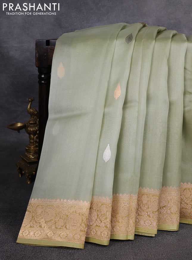 Banarasi organza saree pista green with silver & gold zari woven buttas and zari woven border