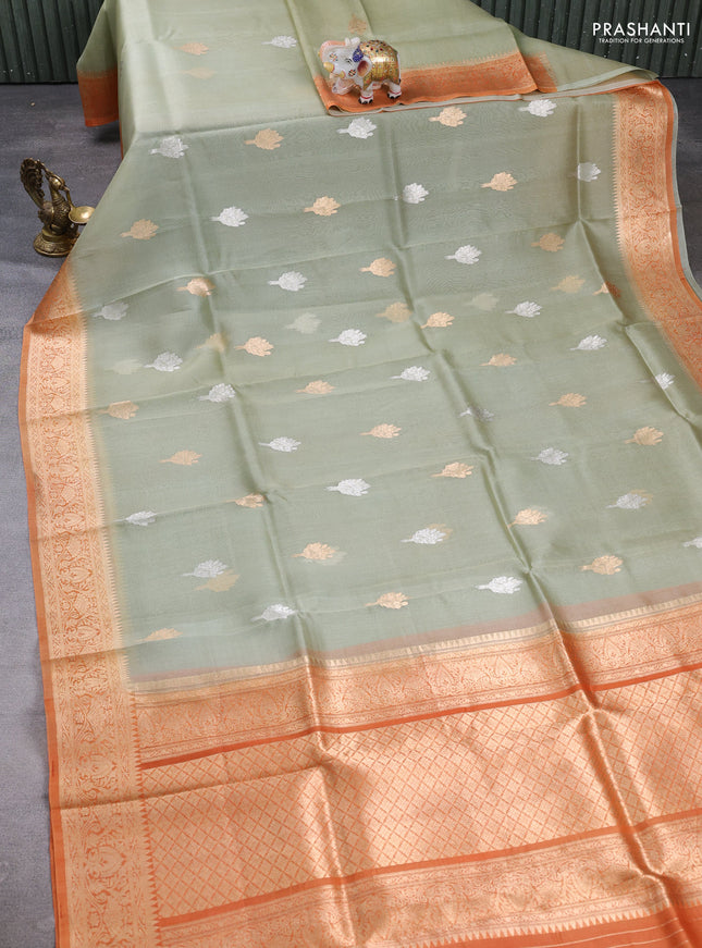 Banarasi organza saree pastel green and orange with zari woven buttas and zari woven border