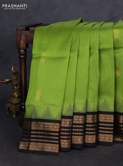 Kuppadam silk cotton saree light green and black with zari woven buttas and temple design zari woven border