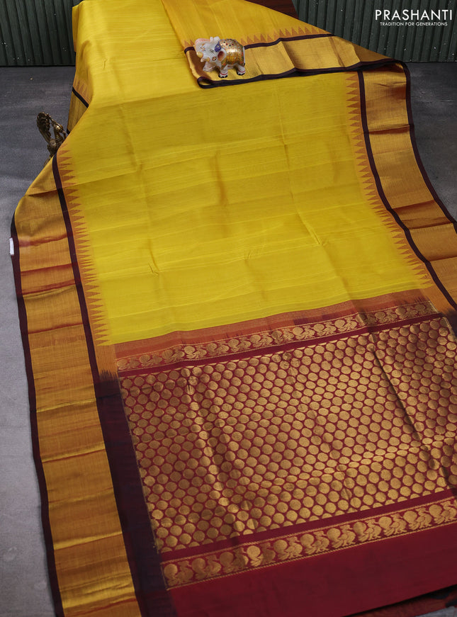 Kuppadam silk cotton saree mustard yellow and maroon with plain body and temple design zari woven border