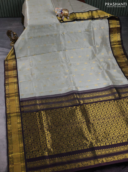 Kuppadam silk cotton saree pastel grey and coffee brown with allover zari woven buttas and zari woven border