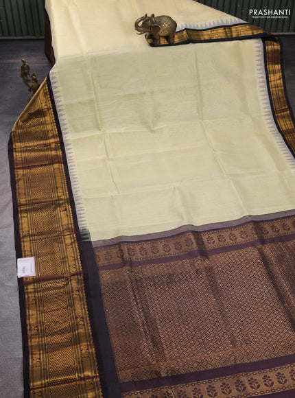 Kuppadam silk cotton saree cream and coffee brown with plain body and temple design long zari woven border