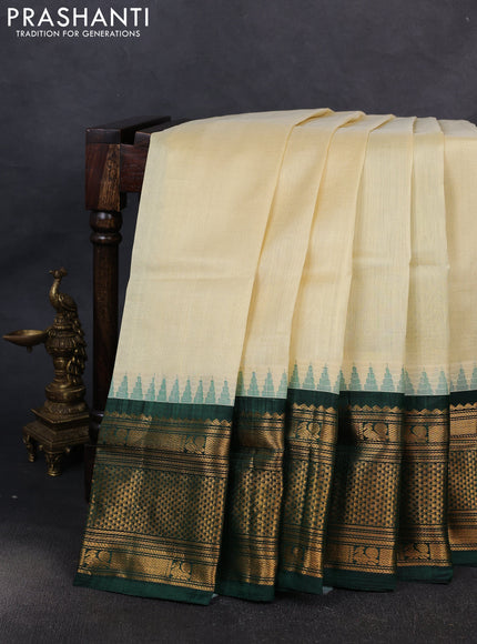 Kuppadam silk cotton saree cream and bottle green with plain body and temple design long zari woven border