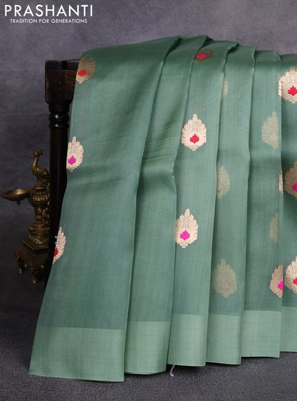 Banarasi organza saree pastel green with zari woven buttas in borderless style