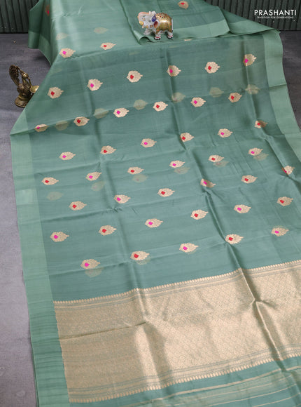 Banarasi organza saree pastel green with zari woven buttas in borderless style
